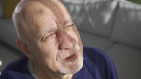 Senior-depressed-old-man-looking-at-camera-with-sad-facial-emotion-expression.
